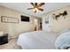 Relaxing bedroom with a ceiling fan, mounted TV, and access to an ensuite bathroom, offering a private retreat at 5778 S Duquesne Ct, Aurora, CO 80016