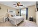 Comfortable bedroom features a large window with blue drapes, carpet and decor at 5778 S Duquesne Ct, Aurora, CO 80016