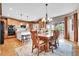 Well-lit dining area off kitchen with wooden table, chairs, and chandelier at 5778 S Duquesne Ct, Aurora, CO 80016