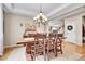 Elegant dining room with a tray ceiling, a chandelier, and wood table for formal gatherings at 5778 S Duquesne Ct, Aurora, CO 80016