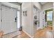 Bright foyer with hardwood floors, white trim, decorative wall hangings and entry to the office at 5778 S Duquesne Ct, Aurora, CO 80016