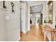 Inviting hallway with hardwood floors, neutral walls, and tasteful decorations and entryway to other rooms at 5778 S Duquesne Ct, Aurora, CO 80016