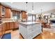 Open kitchen featuring granite countertops and island adjacent to a dining area and living room at 5778 S Duquesne Ct, Aurora, CO 80016
