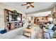 Living room with fireplace, a TV, and view to the kitchen and dining area at 5778 S Duquesne Ct, Aurora, CO 80016