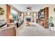 Spacious living room with a fireplace, large windows, and a comfortable leather sofa at 5778 S Duquesne Ct, Aurora, CO 80016