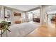 Open-concept living room seamlessly connecting to the dining area with carpet, neutral paint and window at 5778 S Duquesne Ct, Aurora, CO 80016
