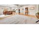 Open-concept living room seamlessly connecting to the dining area and foyer with hardwood floors at 5778 S Duquesne Ct, Aurora, CO 80016