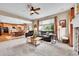 Open living room with fireplace and view of adjacent kitchen and dining area at 5778 S Duquesne Ct, Aurora, CO 80016