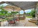 Outdoor living area with a patio, grill, and dining set under a pergola with a large umbrella, perfect for entertaining at 5778 S Duquesne Ct, Aurora, CO 80016