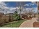 Backyard with a stone walkway, a luscious green lawn, professional landscaping and a wooden fence at 4032 Donnington Cir, Castle Rock, CO 80104