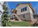 Exterior view of a home with a covered porch, a staircase, a lush lawn and professional landscaping at 4032 Donnington Cir, Castle Rock, CO 80104