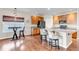 Well-appointed kitchen with a large island and adjacent dining area featuring wood floors at 4032 Donnington Cir, Castle Rock, CO 80104