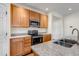 Modern kitchen with granite countertops, wooden cabinets, and stainless steel appliances at 4032 Donnington Cir, Castle Rock, CO 80104