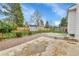 Spacious backyard featuring a concrete patio, brick walkway, shed, and a wooden fence at 7796 S Marshall Ct, Littleton, CO 80128
