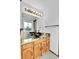 Bathroom with a unique vessel sink, granite countertop, and modern lighting at 7796 S Marshall Ct, Littleton, CO 80128