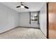 Bedroom featuring a neutral carpet, window with outdoor view, and closet at 7796 S Marshall Ct, Littleton, CO 80128