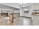 Sunlit dining area with hardwood floors, chandelier, and easy access to the living room at 7796 S Marshall Ct, Littleton, CO 80128