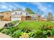 Charming two-story home with brick accents, a well-manicured lawn, and colorful landscaping for added curb appeal at 7796 S Marshall Ct, Littleton, CO 80128
