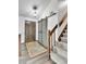 Inviting foyer with wood-look floors, a sliding barn door, and a staircase to the upper level at 7796 S Marshall Ct, Littleton, CO 80128