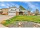 Charming two-story home with a brick facade, well-manicured lawn, and attached two-car garage at 7796 S Marshall Ct, Littleton, CO 80128