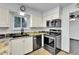 Well-equipped kitchen with stainless steel appliances and granite counters at 7796 S Marshall Ct, Littleton, CO 80128