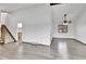 Open-concept living room showcasing wood-look floors, a staircase, and a ceiling fan at 7796 S Marshall Ct, Littleton, CO 80128