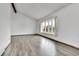 Open living room with wood-look floors and a bright bay window at 7796 S Marshall Ct, Littleton, CO 80128