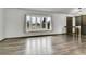 Bright, airy living room with stylish wood-look flooring, and a large bay window at 7796 S Marshall Ct, Littleton, CO 80128