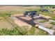 Expansive aerial view of newly constructed home and land, showcasing unique design, driveway, and serene rural setting at 39550 E 142Nd Ct, Hudson, CO 80642