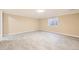 Finished basement area with modern tile flooring and natural light from the window at 1805 August Ln, Brighton, CO 80601