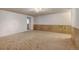 Finished basement with new carpet, wood paneling, and a doorway to another room at 1487 S Zeno Way, Aurora, CO 80017