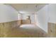 Finished basement space with paneled accent walls and neutral carpet at 1487 S Zeno Way, Aurora, CO 80017