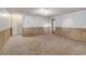 Large carpeted basement with neutral walls and wood paneling at 1487 S Zeno Way, Aurora, CO 80017