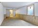 Carpeted basement area with paneled walls and a window at 1487 S Zeno Way, Aurora, CO 80017