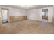 Spacious basement featuring neutral carpet and wood paneling at 1487 S Zeno Way, Aurora, CO 80017