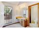 Functional bathroom vanity, sink, lighting, and a view to the outside deck at 1487 S Zeno Way, Aurora, CO 80017