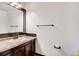Well lit bathroom with decorative vanity, hard surface countertops and bronze fixtures at 1487 S Zeno Way, Aurora, CO 80017