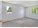 Bright bedroom with neutral carpeting and two windows providing natural light at 1487 S Zeno Way, Aurora, CO 80017