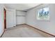 Bedroom includes neutral carpeting, closet and a window providing natural light at 1487 S Zeno Way, Aurora, CO 80017