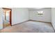 Bedroom with neutral carpet, a window, and a doorway to an adjoining room at 1487 S Zeno Way, Aurora, CO 80017