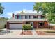 Charming two-story home with a brick facade, shutters, and a well-maintained front yard at 1487 S Zeno Way, Aurora, CO 80017