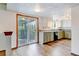Open kitchen leading to an enclosed porch with granite countertops and new vinyl plank flooring at 1487 S Zeno Way, Aurora, CO 80017