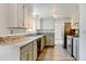 A spacious kitchen with granite countertops, stainless appliances and two-tone cabinets at 1487 S Zeno Way, Aurora, CO 80017