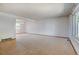 Spacious living room features neutral carpeting and a window providing natural light at 1487 S Zeno Way, Aurora, CO 80017