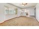 Bright living room featuring new paint, neutral carpet, and a pass-through to the kitchen at 1487 S Zeno Way, Aurora, CO 80017
