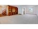 Living room features a wood-panel built-in bookshelf and neutral carpeting at 1487 S Zeno Way, Aurora, CO 80017