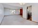 Living room features a view into the kitchen and neutral carpeting at 1487 S Zeno Way, Aurora, CO 80017