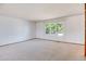 Bright living room featuring neutral carpet and trim and a large window at 1487 S Zeno Way, Aurora, CO 80017