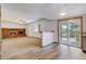 Spacious living room with a brick fireplace and sliding doors to an enclosed porch at 1487 S Zeno Way, Aurora, CO 80017