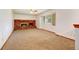 Spacious living room with a brick fireplace and new carpet at 1487 S Zeno Way, Aurora, CO 80017